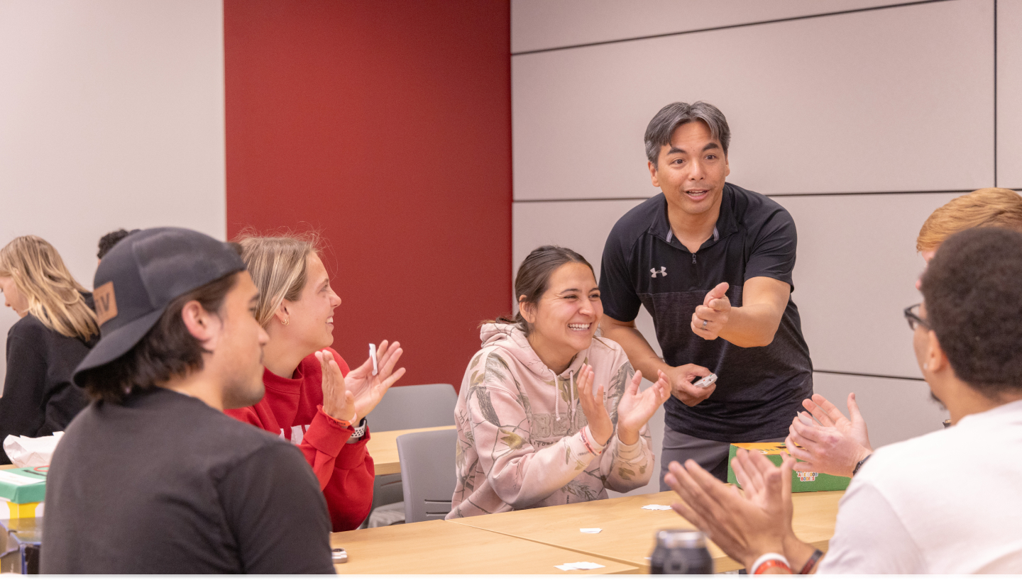 Professor giving an active lecture and talking with students