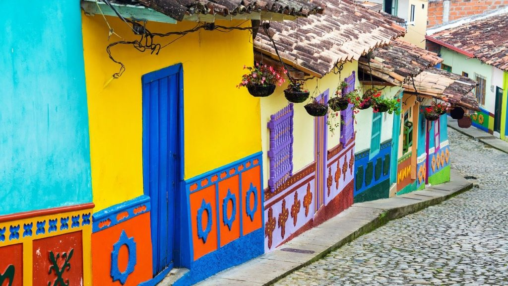 Colorful Buildings on a road that is a steep hill.
