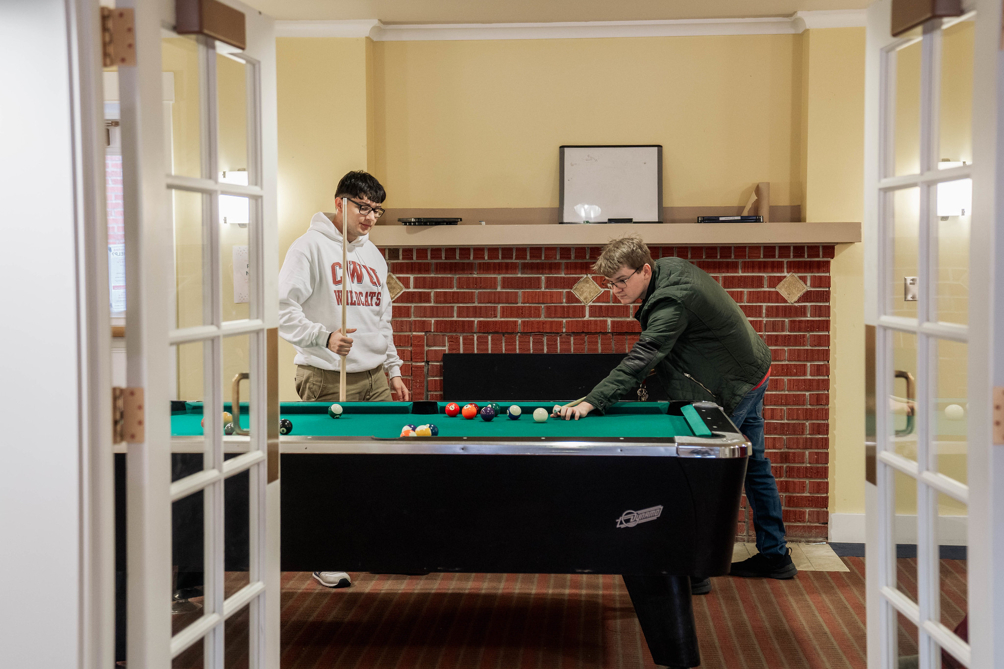 Two students playing pool