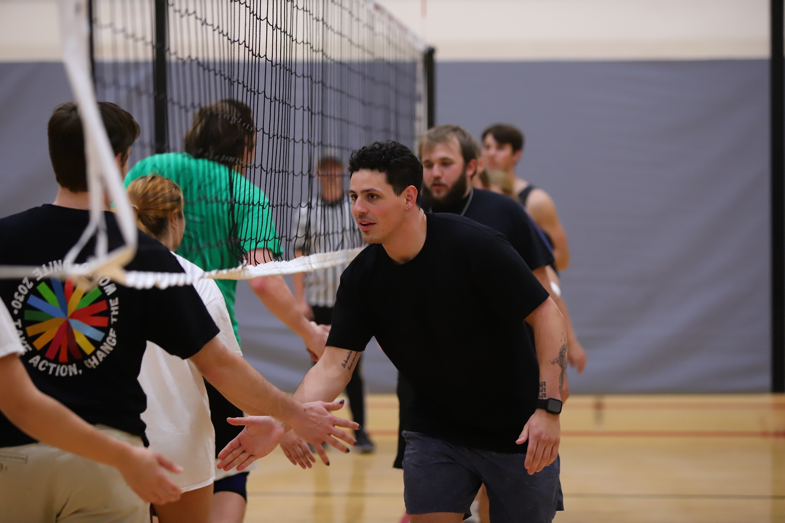 Two volleyball players low fiving